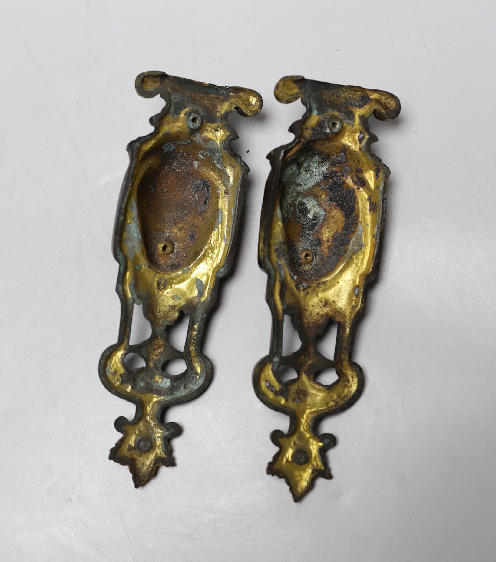 A pair of 19th century French parcel gilt furniture mounts, 18cm